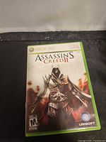 Front view of Assassin's Creed II Xbox 360 case