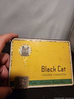 Front view of tin showing logo, brand text and tax stamp