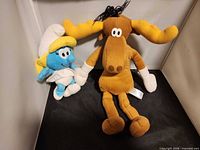 Both plush toys standing side by side showing relative sizes