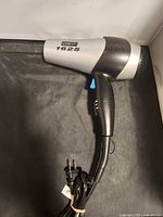 Conair model 1625 hair dryer with cord, speed switch and nozzle visible