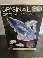 Front of sealed box showing shark puzzle image, branding and details
