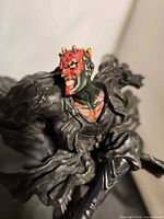 Close-up of Darth Maul head and upper torso showing facial detail and robe texture