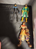 Three action figures laid out together