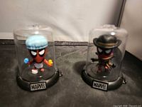 Both Deadpool capsule figures displayed side by side