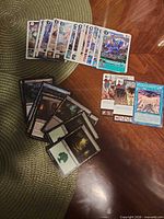 Group shot showing Digimon cards in deck, Magic: The Gathering stack, Yu-Gi-Oh! card and two anime cards