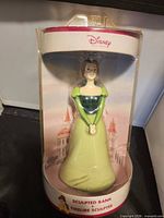 Front view of sealed Belle sculpted bank in original packaging