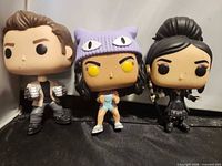 Three vinyl figures standing side by side, showing overall lot contents