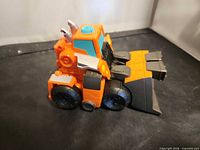 Figure in bulldozer vehicle mode, side/front view