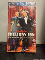 Front view of sealed Holiday Inn VHS showing artwork and stars