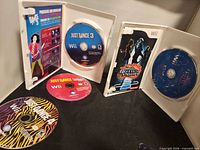 All four game discs with two cases open showing contents