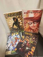 All four bagged comics/graphic novel front covers visible