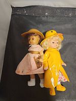 Both dolls side by side showing outfits
