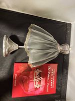 Mannequin stand lying beside book