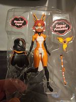 Front view of Rena Rouge figure in blister with accessories