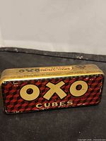 Front view of OXO Cubes tin showing logo and pattern