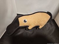 Side view of quilted tan and black platypus plush