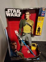 Front of box showing figure and lightsaber