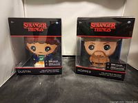 Front view of both boxed squishy figures Dustin and Hopper