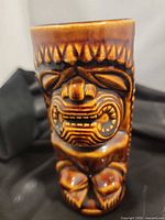 Front view showing carved tiki face design