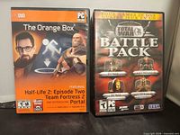 Front covers of The Orange Box and Total War Battle Pack cases