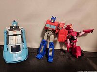Three Transformers figures standing together