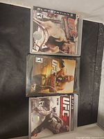 Front view of three PS3 UFC Undisputed game cases