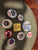 Overall lot view showing all nine pinbacks
