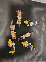 Top view of all six Disney corn holders showing character designs and prongs