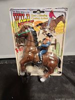 Front view of sealed Wild West galloping cowboy toy showing full package