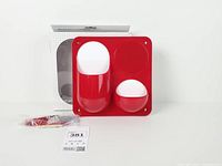 Front view of red two-pocket wall organizer, hardware bag, original box