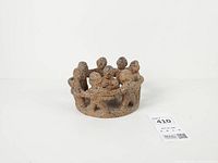 Front view of terracotta circle of friends candle holder