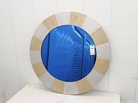 Front view showing blue mirror center and full sunburst frame