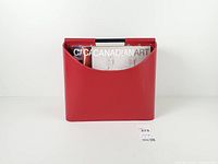 front view showing red bonded leather basket holding magazines