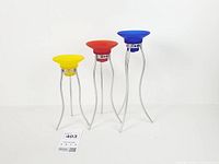 Three coloured candle holders displayed to show size difference and design