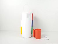 pitcher front, one orange mug separated, other mugs stacked behind