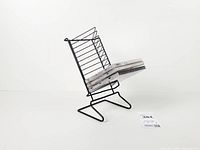 Side view of black metal wire CD rack holding CDs