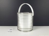 Full view showing ribbed bucket, handle raised, liner visible