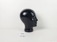 Right profile view of black glass mannequin head showing hammered texture and glossy finish