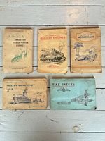 Five completed cigarette-card albums front covers visible