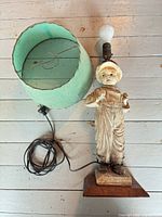 Full view of statue lamp with detached shade, cord, and bulb
