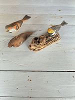 Top view of both bird carvings on driftwood bases