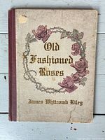 Front cover with title, rose wreath and visible wear