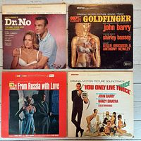 Front covers of Dr. No, Goldfinger, From Russia with Love, You Only Live Twice