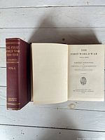 Volume I opened to title page alongside closed Volume II