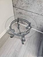 Overhead view of one table showing round glass top and metal base