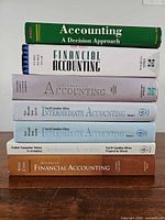 Front spines of six accounting textbooks showing titles and editions