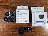Open box view showing camera, USB cable, magnetic base, second box and manual