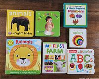 Front covers of all seven board books displayed