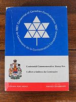 Front of Centennial Commemorative Stamp Box showing title and emblem