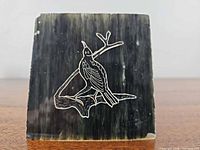 Front view showing engraved bird design and stone colour